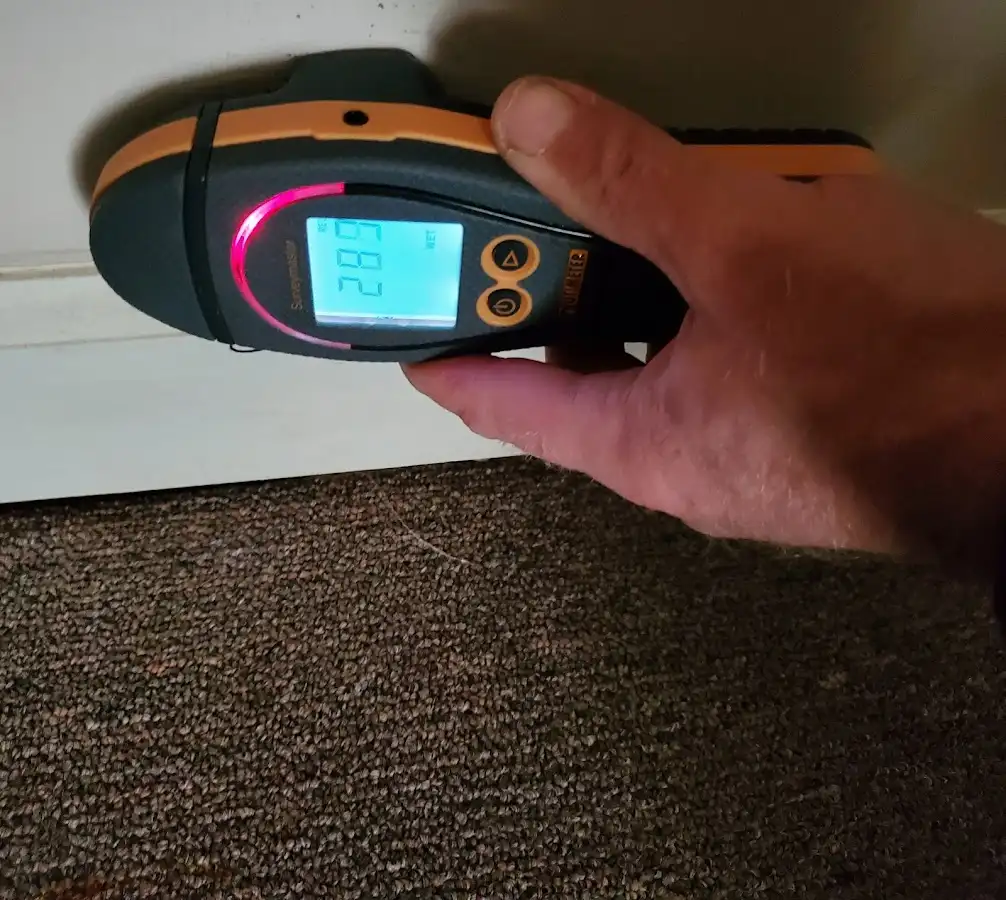 Moisture detection at baseboard during Storm Damage Restoration in Clermont